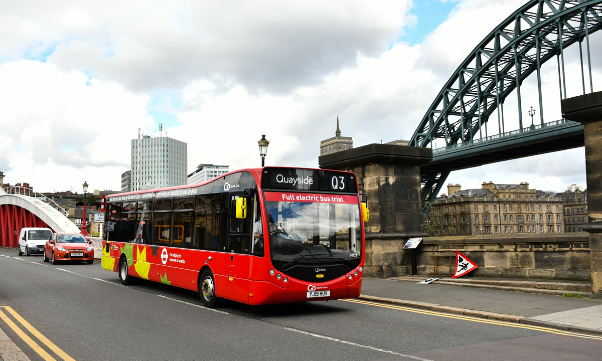 Electric bus crossing Swing Bridge with the Tyne Bridge in the background